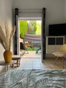 a bedroom with a door open to a patio at Caza Bodo in Sausset-les-Pins