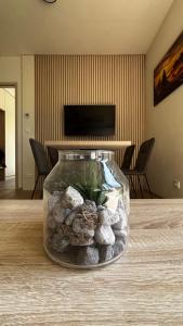a vase filled with rocks on top of a table at Apartmán Jasanek in Železná Ruda