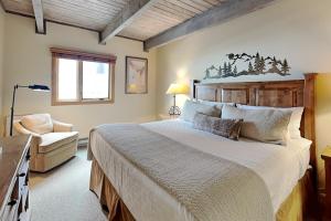 a bedroom with a large bed and a chair at Timberline Condominiums 3 Bedroom Deluxe Unit D2E in Snowmass Village