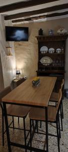 a wooden table in a living room with a table and chairs at El Rincón de la Magia in Soportújar