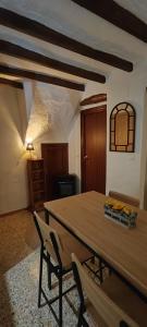 a dining room with a wooden table and chairs at El Rincón de la Magia in Soportújar