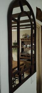 a mirror reflection of a dining room with a table at El Rincón de la Magia in Soportújar