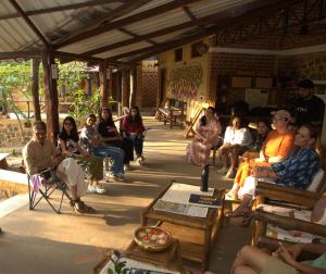 a group of people sitting in chairs in a room at Surwahi Social Ecoestate Kanha in Kānha