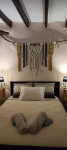 a bedroom with a bed with two pillows on it at El Rincón de la Magia in Soportújar