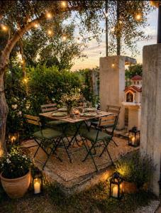 a table and chairs in a garden with lights at Country House in Sozopoli