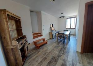 a living room with a table and a dining room at Borgo Tibetano in Castelsaraceno