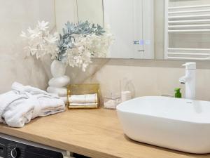 a bathroom with a white sink and a mirror at Inamstro Home in Orhei +22 photos