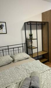 a bedroom with a bed and a shelf at Apartamenty Rybna 1 Centrum in Tarnów