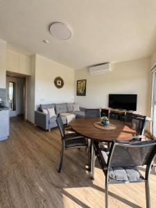 a living room with a table and a couch at Guest House Klevu 17 in Palanga