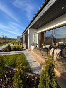 a deck with a view of a house at Guest House Klevu 17 in Palanga
