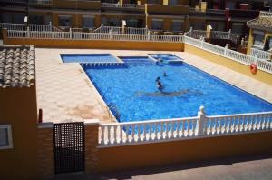 a person swimming in a large swimming pool at Casa Laguna Torrevieja in Torrevieja