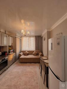 a living room with a couch and a refrigerator at RentHouse Apartments Premium Living in Chişinău