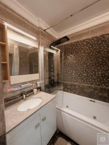 a bathroom with a sink and a mirror at RentHouse Apartments Premium Living in Chişinău +30 photos