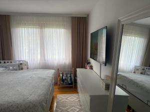 a bedroom with two beds and a mirror at Butmir house-Sarajevo in Sarajevo