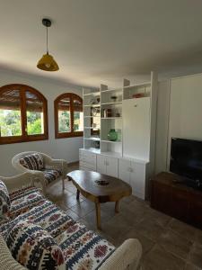 a living room with a couch and a coffee table at L'Estança de Can Rodó in Vilobí d'Onyar