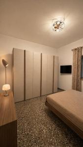 a bedroom with a large bed and a television at Una rosa sul mare Monopoli in Monopoli