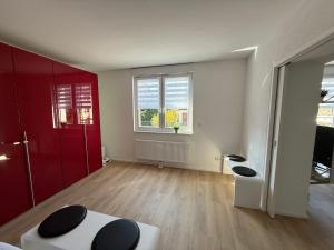 an empty living room with red and white walls at Ferienwohnung Ruhepunkt Dessau - zentral nahe Bauhaus und Meisterhäusern - mit gratis WLAN und Parken sowie Komplettküche in Dessau