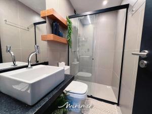 a bathroom with a sink and a toilet and a shower at Emunah-Ponta de Campina Cabedelo in Cabedelo