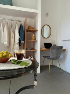a room with a table and a chair and a mirror at Mikro Kastro in Amorgos