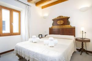 a bedroom with two beds with white sheets at Ca Sa Padrina in Artá +22 photos