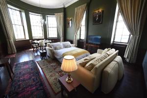 a bedroom with a bed and a couch and a table at Cupar Burgh Chambers in Cupar