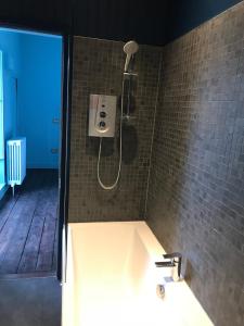 a bathroom with a shower with a sink at Cupar Burgh Chambers in Cupar +27 photos