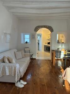 a living room with a couch and a kitchen at Mikro Kastro in Amorgos
