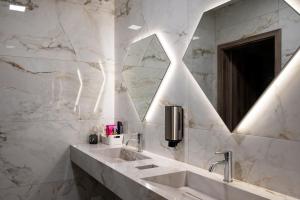 a bathroom with a sink and a mirror at Diamond2 Hotel in Zagreb