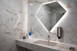 a bathroom with a sink and a mirror at Diamond2 Hotel in Zagreb +31 photos