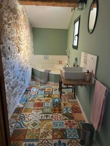 a bathroom with a sink and a tub at L'Amandine in Puisserguier +19 photos