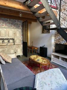 a living room with a couch and a coffee table at L'Amandine in Puisserguier