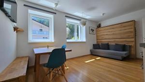 a living room with a table and a couch at Ski & Sky Apartment in Hinterstoder