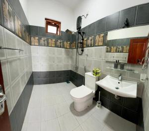 a bathroom with a toilet and a sink at Hamilton Breeze villa in Pamunugama +22 photos