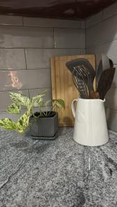 a white blender sitting on a counter next to a plant at Hamilton Breeze villa in Pamunugama