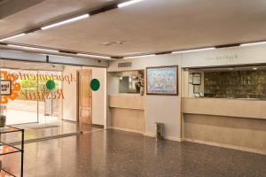 a hallway of a building with a sign on the wall at Apartamentos Resitur in Seville