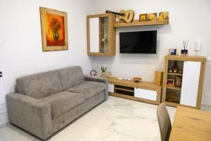 a living room with a couch and a flat screen tv at Dimora Ambrosio 108 in San Giuseppe Vesuviano