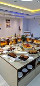 a buffet line with many different types of food at Blue sky hotel in Oran