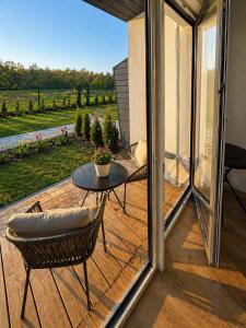 a patio with a table and chairs on a wooden deck at Guest House Klevu 17 in Palanga +14 photos