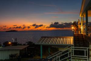 a sunset from a house with the ocean in the background at Posada Three Cay Suites in Providencia