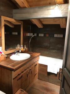 a bathroom with a sink and a mirror at Chalet ANTARÈS in Manigod