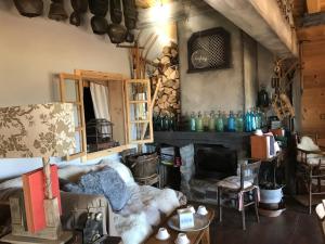 a living room with a couch and a fireplace at Chalet ANTARÈS in Manigod