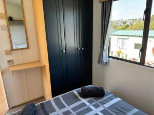 a bedroom with a bed and a window with a view at Cornish Dreams - WiFi in Newquay