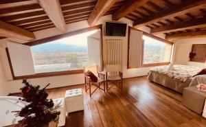 a bedroom with a large window and a bed and a tub at Corte Fratini Appartamenti in Trevi +94 photos