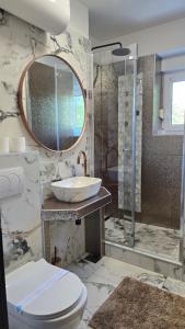 a bathroom with a toilet and a sink and a mirror at Apartman NIKOL in Senj +26 photos