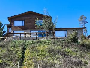 a house sitting on top of a hill at Casa Hotel Los Arrayanes in Constitución