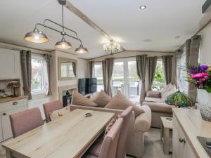 a living room with a couch and a table at Carp Lodge in Carnforth