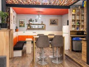 a kitchen with a table and chairs in a room at Mouse House in Chişinău +47 photos