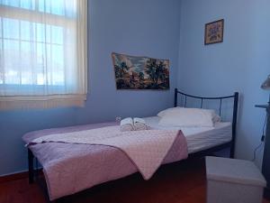 a bedroom with two beds and a window at Traditional Villa Marina in Chios