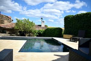 a swimming pool in the yard of a house at Casa Rural El Bornizo con psicina jacuzzi climatizado barbacoa y jardín en Salamanca in Pastores +20 photos