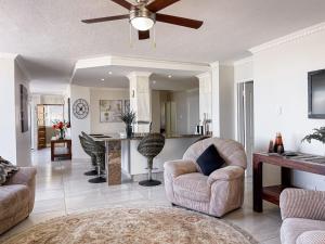 a living room with a couch and a ceiling fan at Rondevoux 17 in Margate